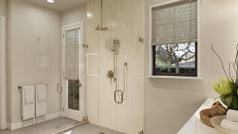 Modern bathroom with a glass-enclosed shower, beige tiled walls, a window with blinds, and a sink with decorative items.