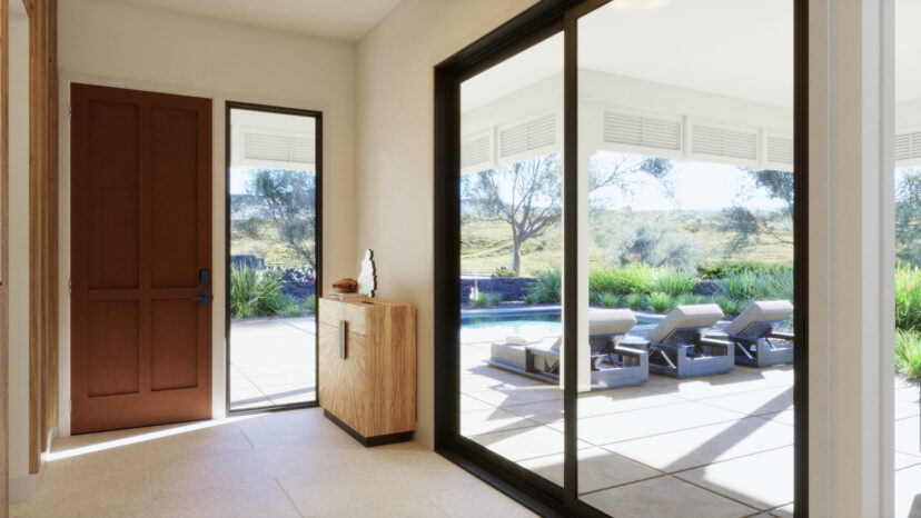 Modern entryway with a wooden door, a side table, and large glass doors leading to a patio. The patio features lounge chairs overlooking a garden with trees in the background.