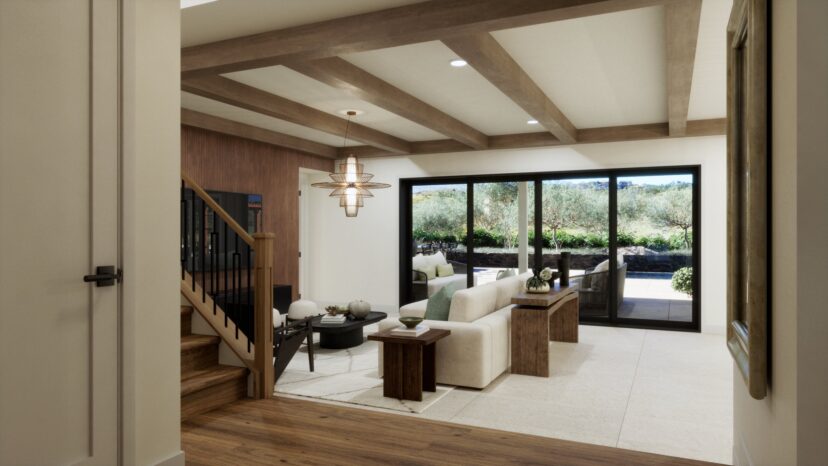 Modern living room with a cream sofa, dark wood coffee table, and large sliding glass doors leading to a patio. Wooden beams on ceiling and a staircase with black railing are visible.