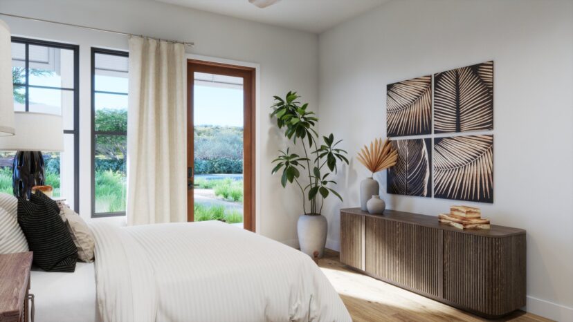 A bright bedroom with a bed, wooden sideboard, plant, and artwork on the wall. Glass doors open to a green garden view.